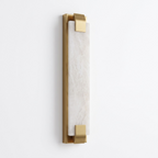Studio shot of this Clérachic panel sconce in brass finish, its flat alabaster panel held by clips top and bottom.