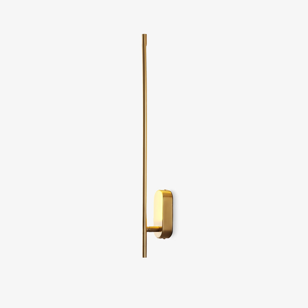 Brass stick-shaped wall sconce mounted in a reading nook