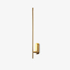 Brass stick-shaped wall sconce mounted in a reading nook