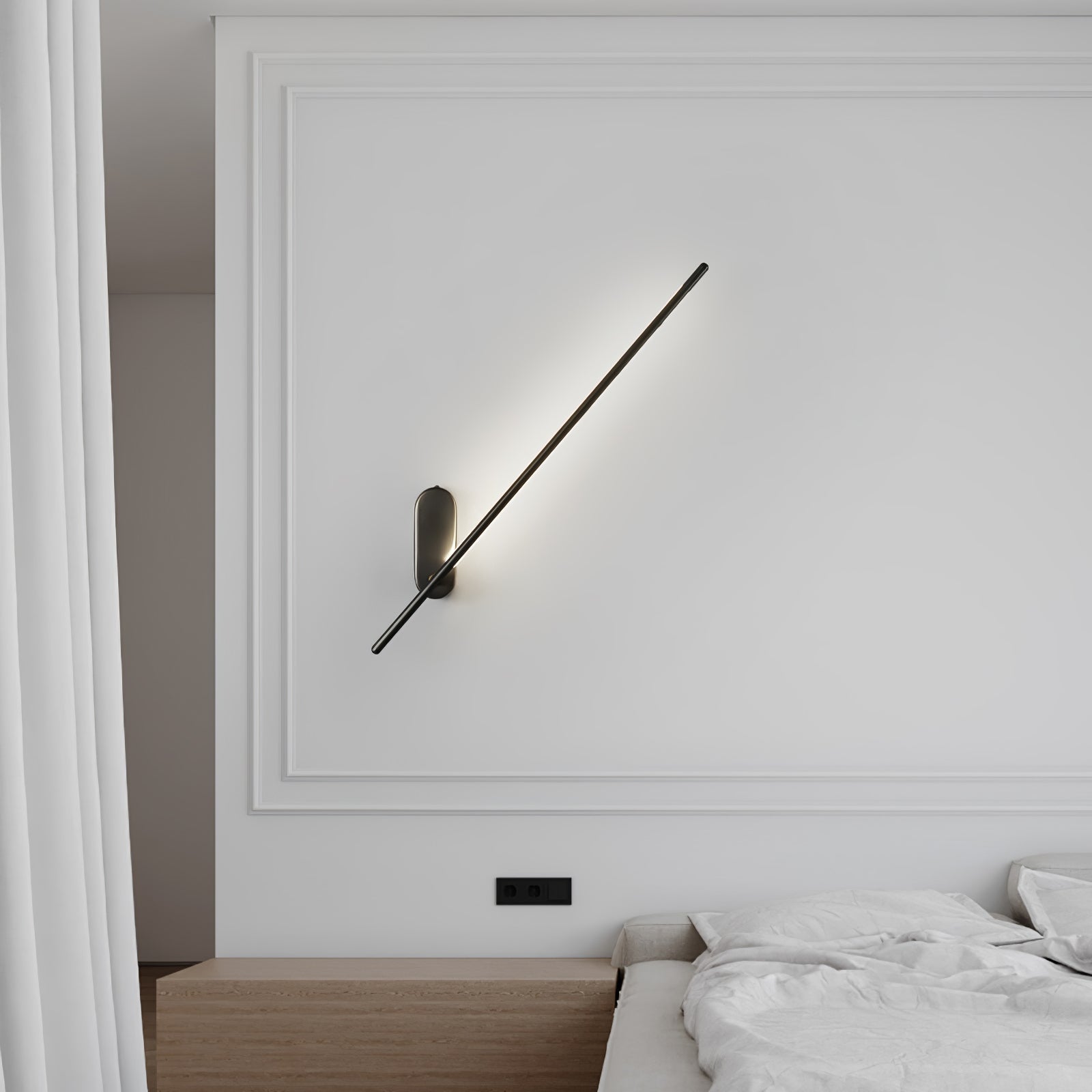 Stick wall sconce in black finish lit beside a doorway
