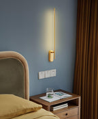 Slim wall sconce drawing a tall line of warm light