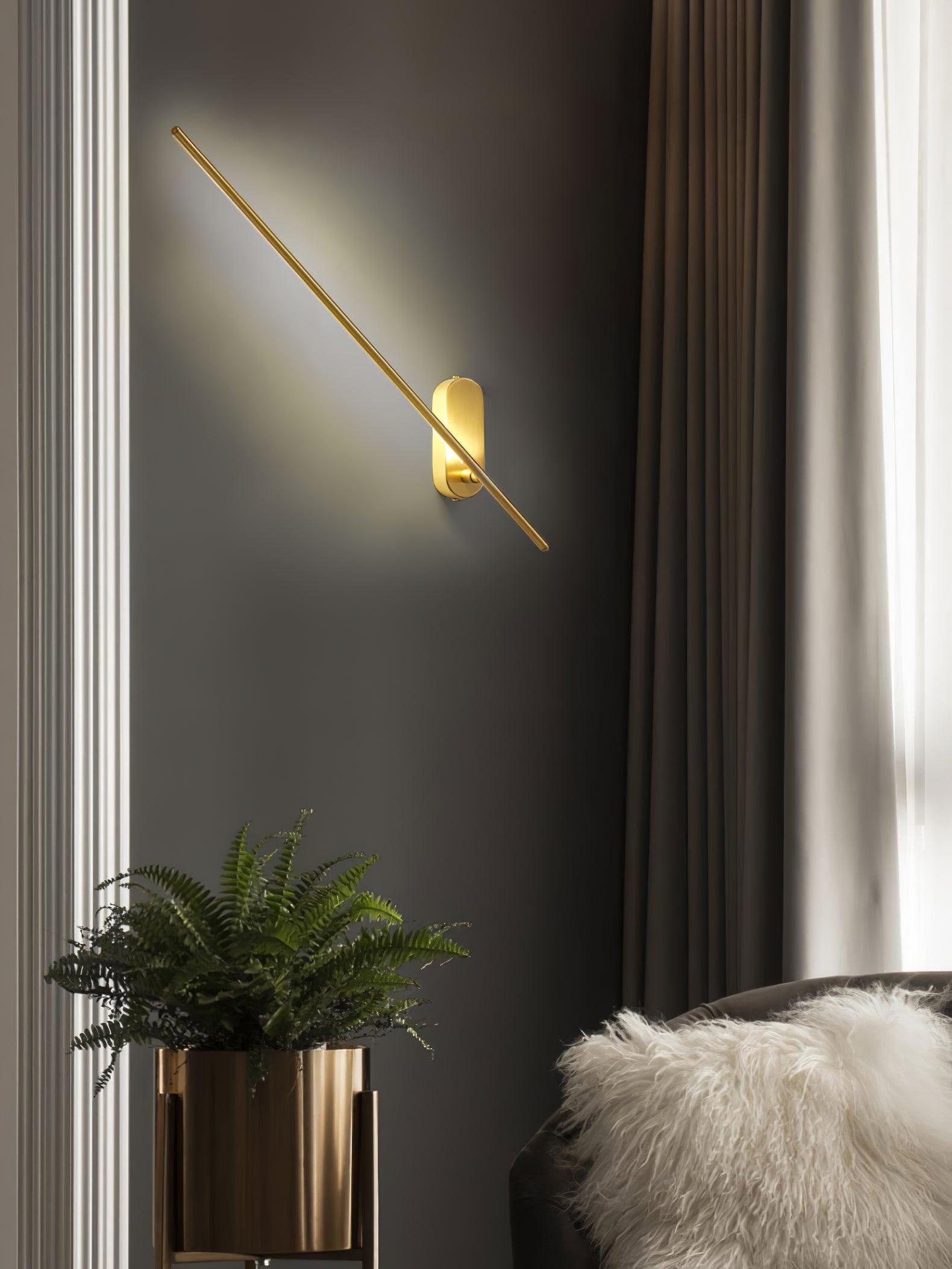 Stick-shaped sconce in black glowing in a quiet corner
