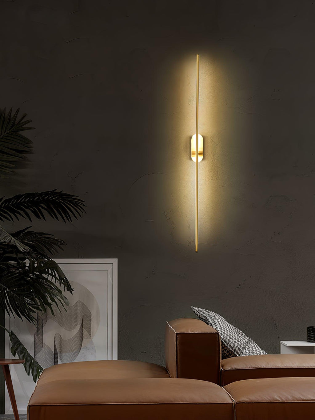 Brass stick wall sconce glowing softly in an interior