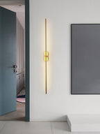 Slim linear wall sconce mounted neatly on a bedroom wall