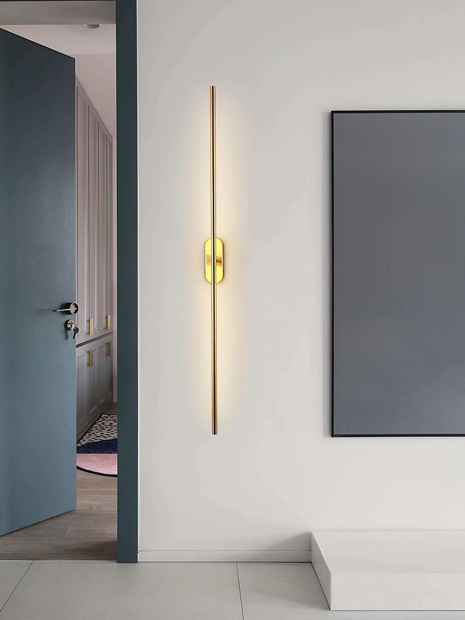 Slim linear wall sconce mounted neatly on a bedroom wall