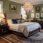 In a sage-green bedroom with a gallery wall, this silver Clérachic chandelier hangs lit above a four-poster bed.