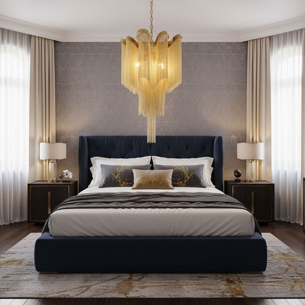 This gold Clérachic chandelier hangs lit above a navy upholstered bed, flanked by matching bedside lamps.