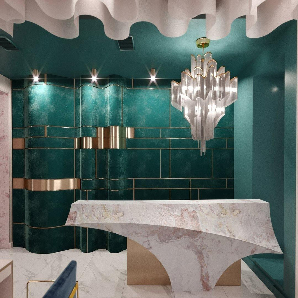 In a teal-tiled powder room with a marble vanity, this silver Clérachic chandelier hangs lit overhead.