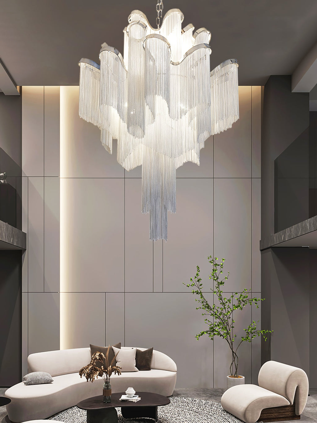 Curved white sofas sit beneath this lit silver Clérachic chandelier in a dark-toned round lounge.