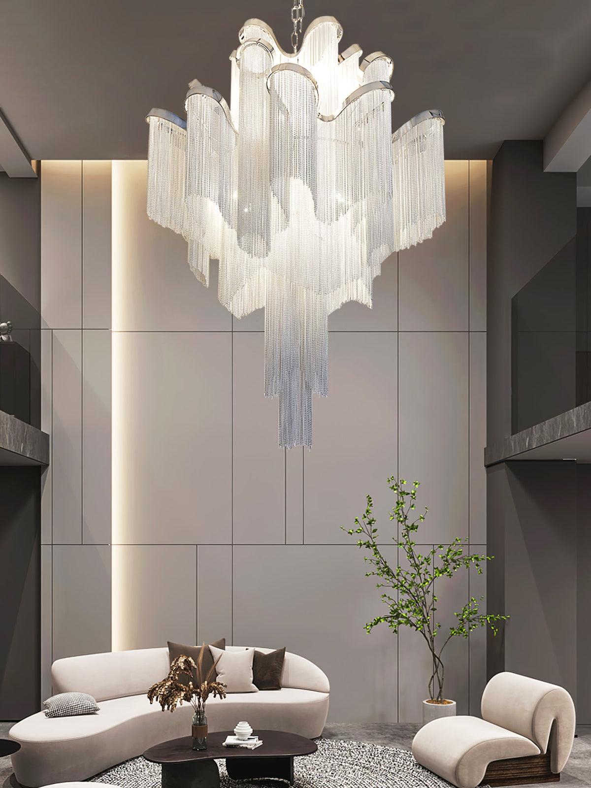 Curved white sofas sit beneath this lit silver Clérachic chandelier in a dark-toned round lounge.