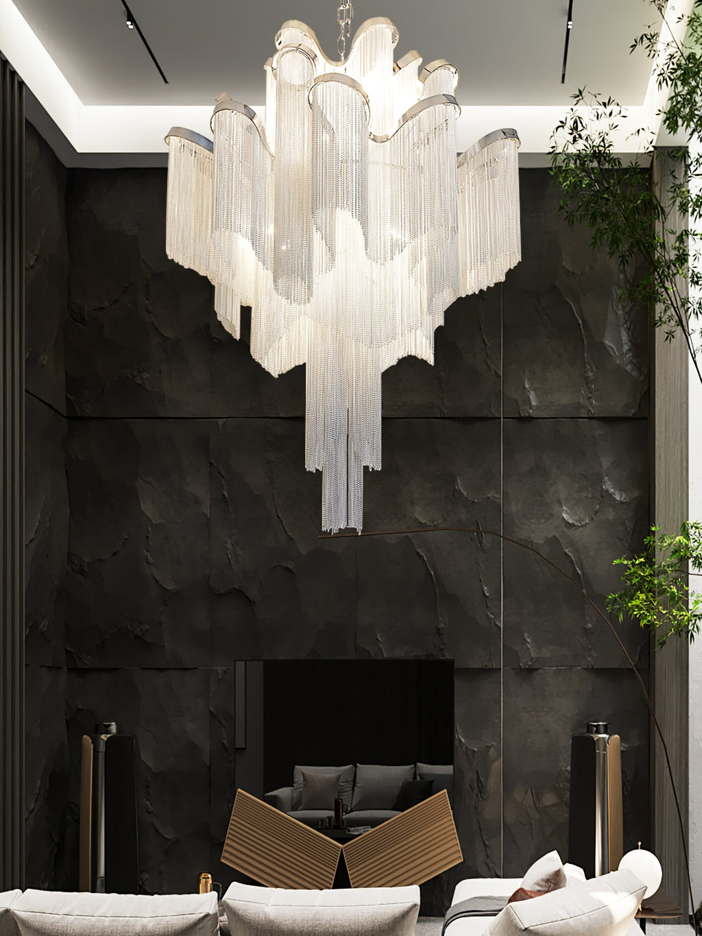 Set against a black stone wall near a dark fireplace, this lit silver Clérachic chandelier glows softly.