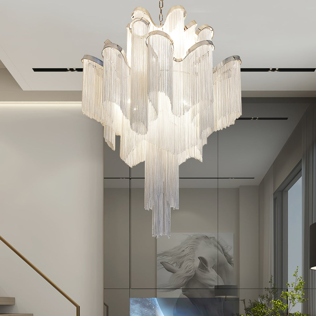 Framed horse artwork and glass display panels line the hallway beneath this lit silver Clérachic chandelier.