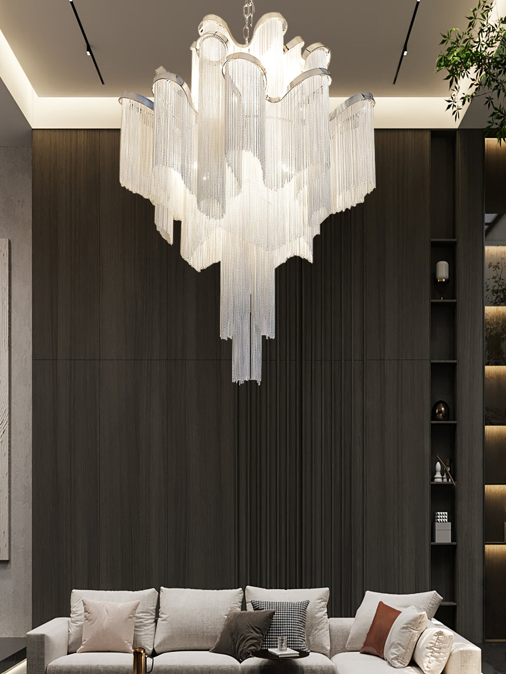 A beige sofa and scatter cushions sit beneath this lit silver Clérachic chandelier in a dark-panelled living room.