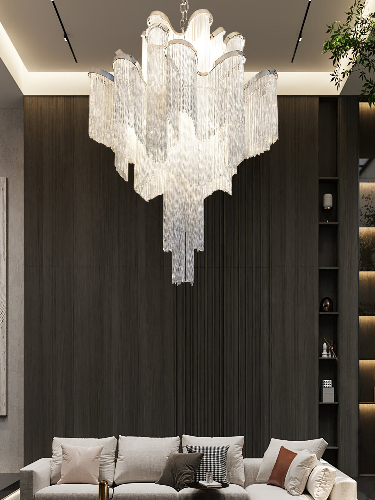 A beige sofa and scatter cushions sit beneath this lit silver Clérachic chandelier in a dark-panelled living room.