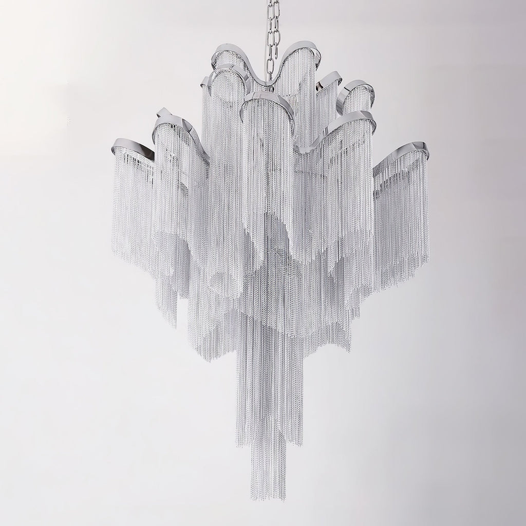 On a plain grey-white backdrop, this lit silver Clérachic chandelier is shown with its tiers fully spread.