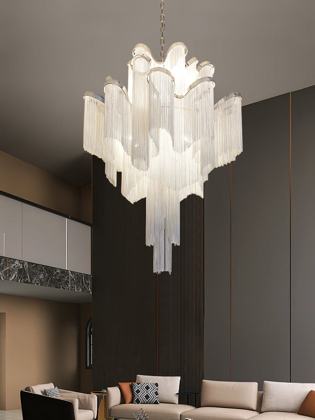 A beige sofa and patterned cushions sit beneath this lit silver Clérachic chandelier in a dark-wood living room.