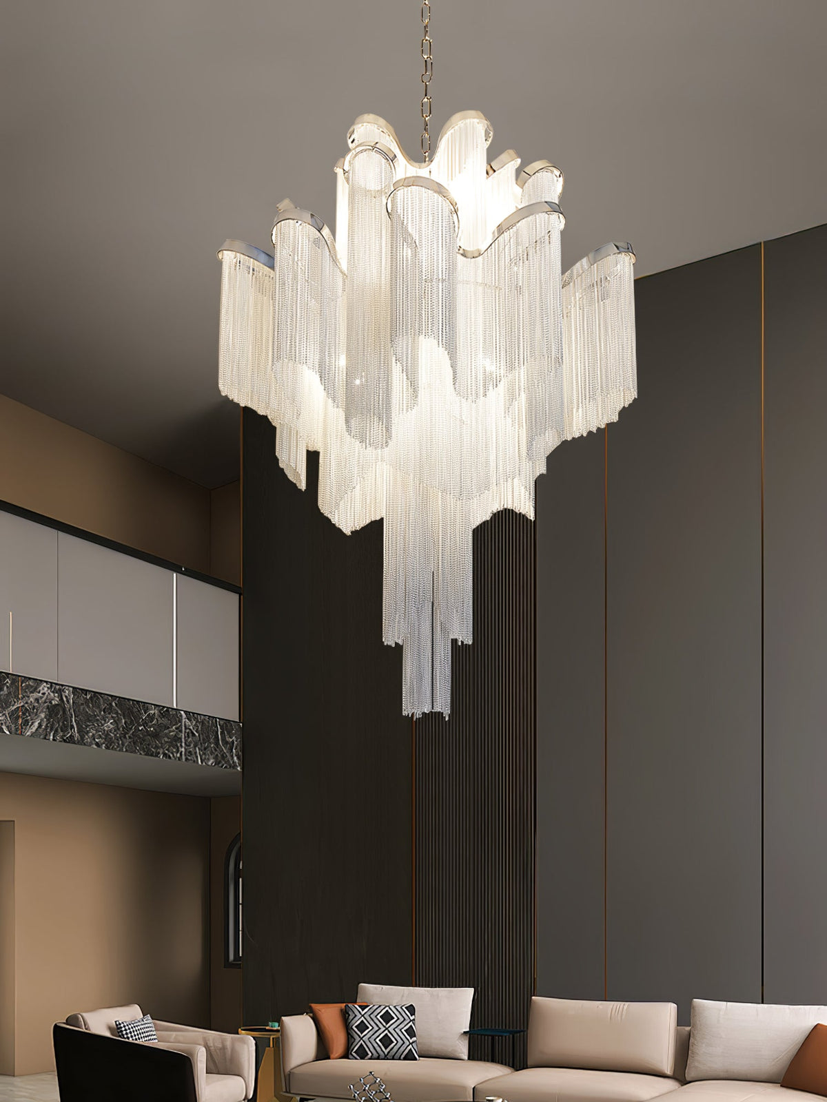 A beige sofa and patterned cushions sit beneath this lit silver Clérachic chandelier in a dark-wood living room.