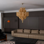 Seen slightly further back, this lit gold Clérachic chandelier hangs in the same dark-panelled lounge.