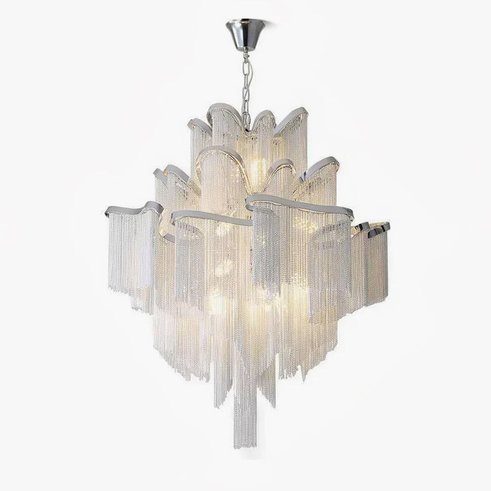 This silver Clérachic chandelier is lit and tiered, photographed against a soft plain backdrop with its fringe fully spread.