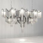 Spread wide on a plain backdrop, this lit silver Clérachic chandelier shows its horizontal chain form.