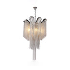 This smaller lit silver Clérachic chandelier is shown against a white backdrop with its chain hanging in tiers.