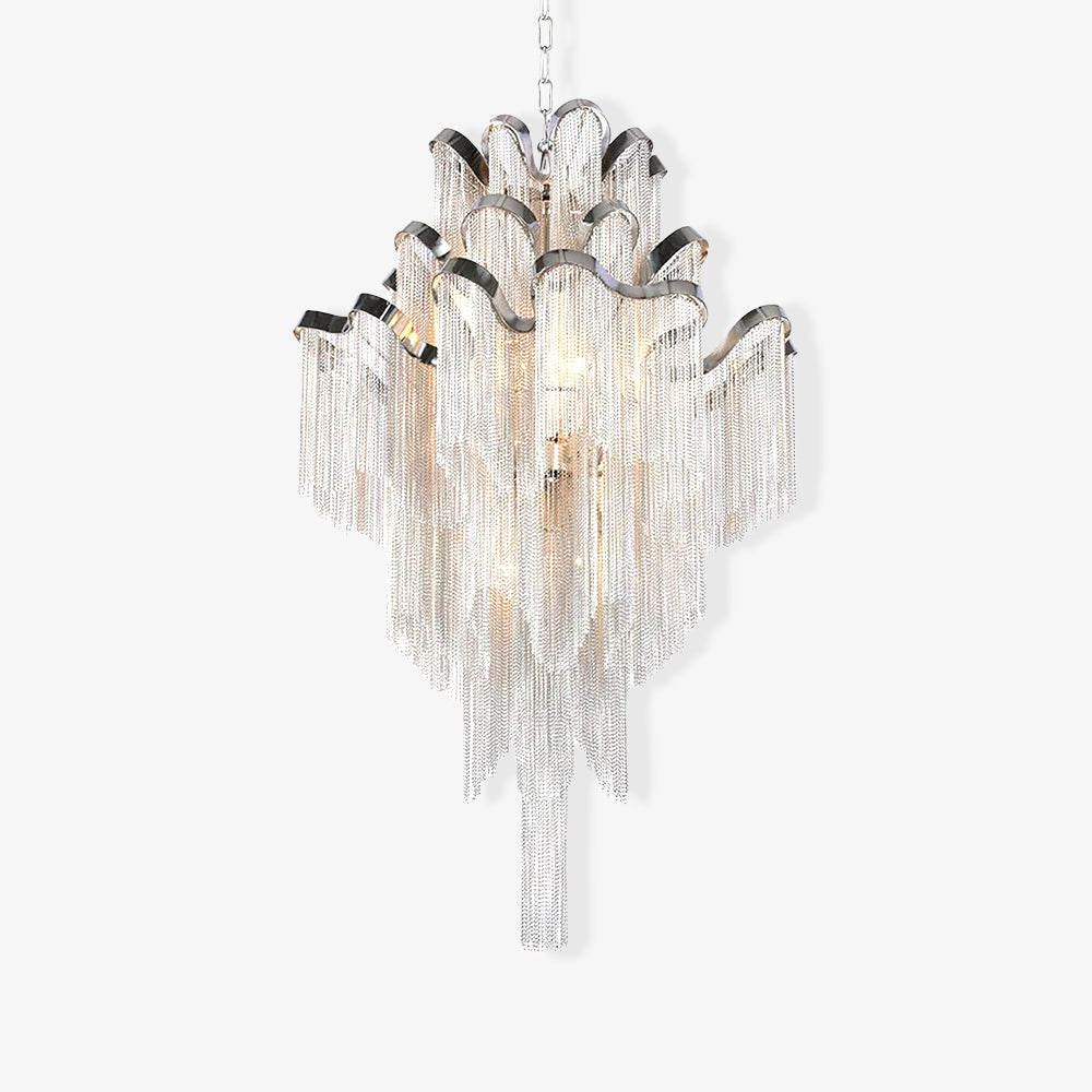 On a white backdrop, this lit silver Clérachic chandelier is shown close with its full tiered chain fringe visible.