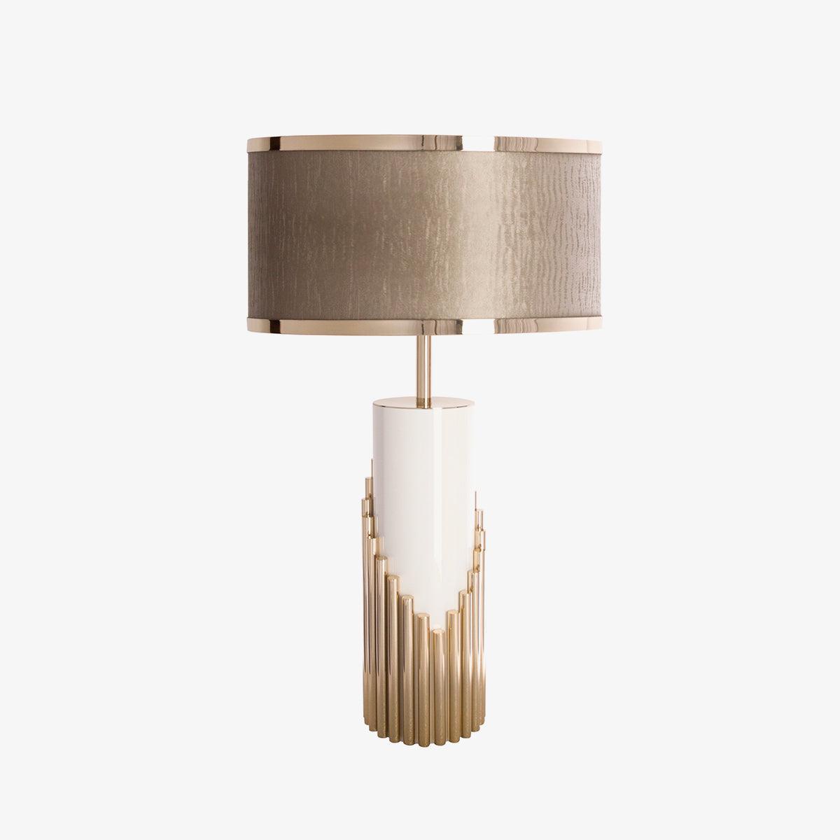 A second studio view of this Clérachic table lamp shows its fabric drum shade and gold stepped base against a plain backdrop.