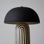 A larger studio crop shows this Clérachic table lamp's matte black dome shade above the black-and-white striped base.
