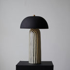 Seen from another angle on its black plinth, this Clérachic table lamp's black-and-white stripes wrap the rounded ceramic base.