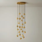 The twenty-one-light Sultana chandelier at full drop, globes falling in a deep column of warm light.