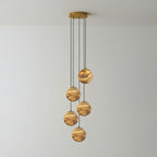 The five-light Sultana chandelier, five alabaster globes dropping at staggered lengths from a gold plate.