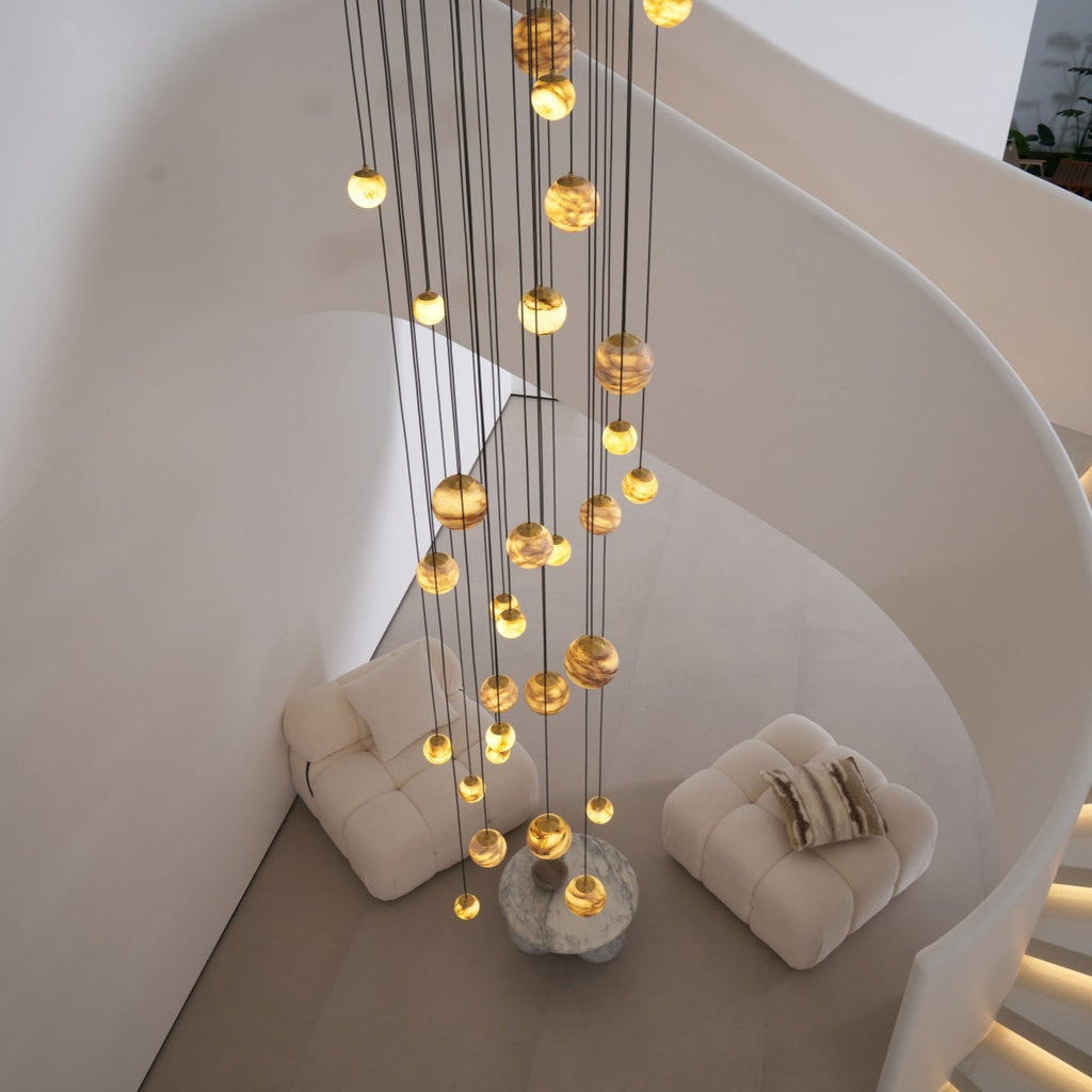 The Sultana chandelier seen from above, dropping through a curved stairwell to the lounge below.