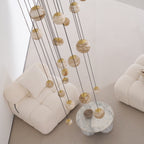 The chandelier unlit in daylight, its pale alabaster globes reading as veined cream stone from above.