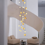 Close daylight view of the lit cascade, larger globes at the centre and smaller ones toward the edges.