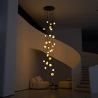 Wide night shot with the Sultana chandelier as the only light source in the darkened stairwell.