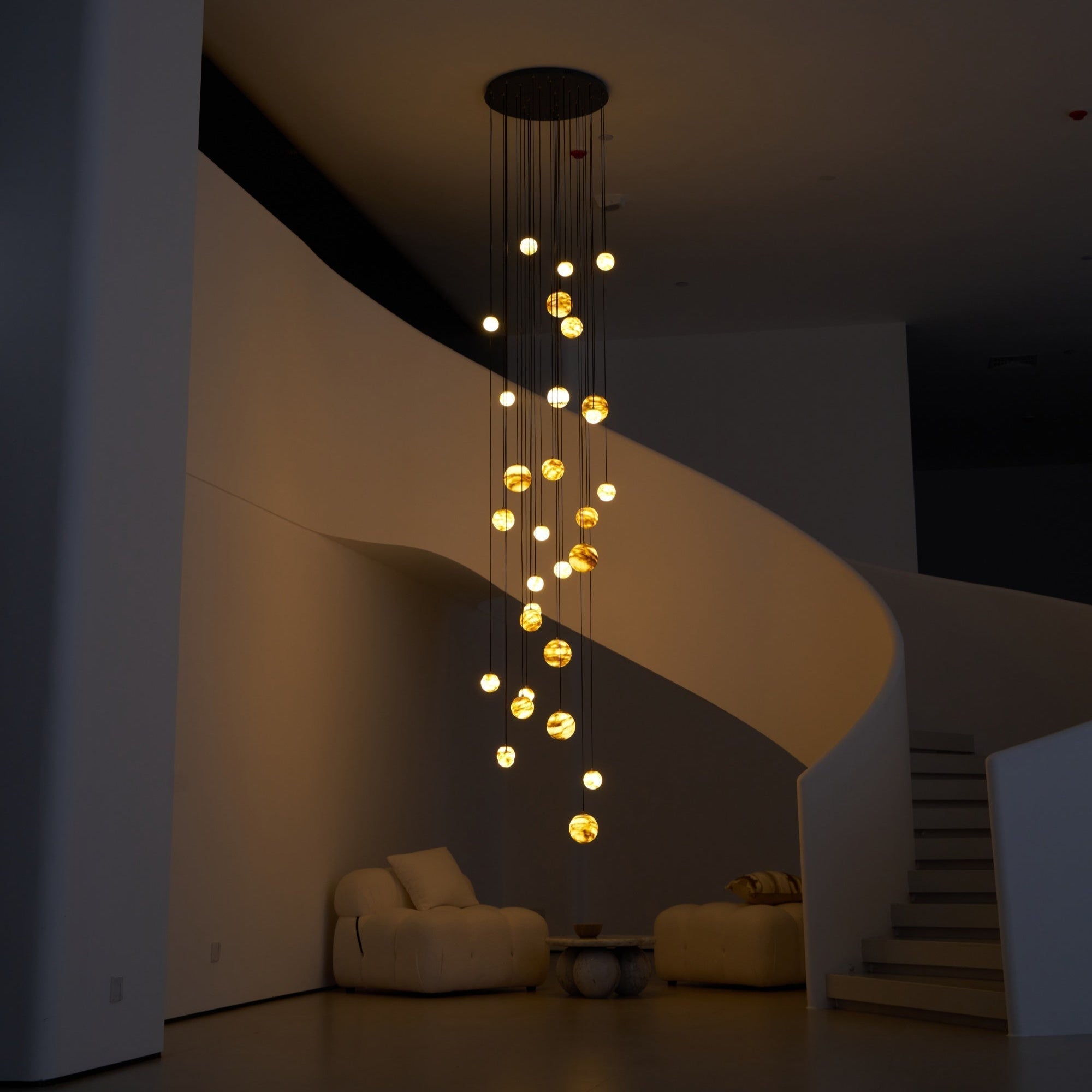 Wide night shot with the Sultana chandelier as the only light source in the darkened stairwell.