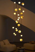Close night view of the glowing globes and the diagonal shadow the staircase casts behind them.