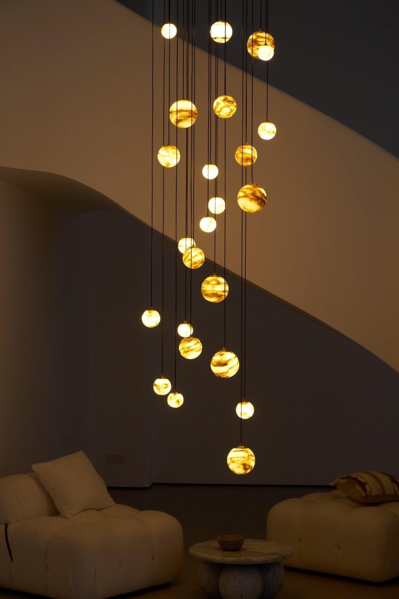 Close night view of the glowing globes and the diagonal shadow the staircase casts behind them.