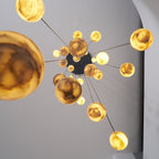 Looking straight up into the chandelier, globes radiating out from the round black ceiling plate.