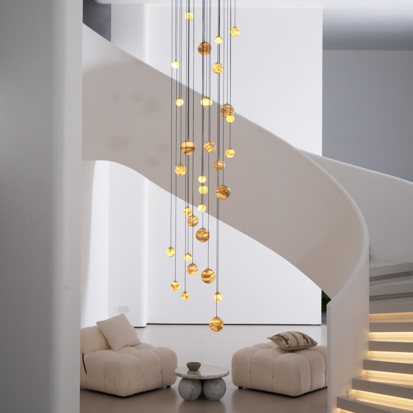 Daylight side view of the chandelier showing the full spiral arrangement of its alabaster globes.