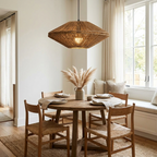 Over a round table dressed with pampas grass, this Clérachic pendant hangs near a cushioned window seat.