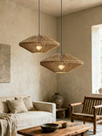 Two of this Clérachic pendant hang side by side above a linen sofa and a low wood bench.