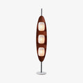 Clérachic teak-finish floor lamp with three stacked white glass shades, shown full length on a plain light studio backdrop.