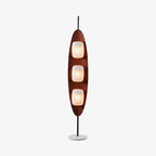 Clérachic teak-finish floor lamp with three stacked white glass shades, shown full length on a plain light studio backdrop.