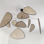A close ceiling view of this Clérachic pendant shows its black wire frame fanned beneath a plain white ceiling rose.