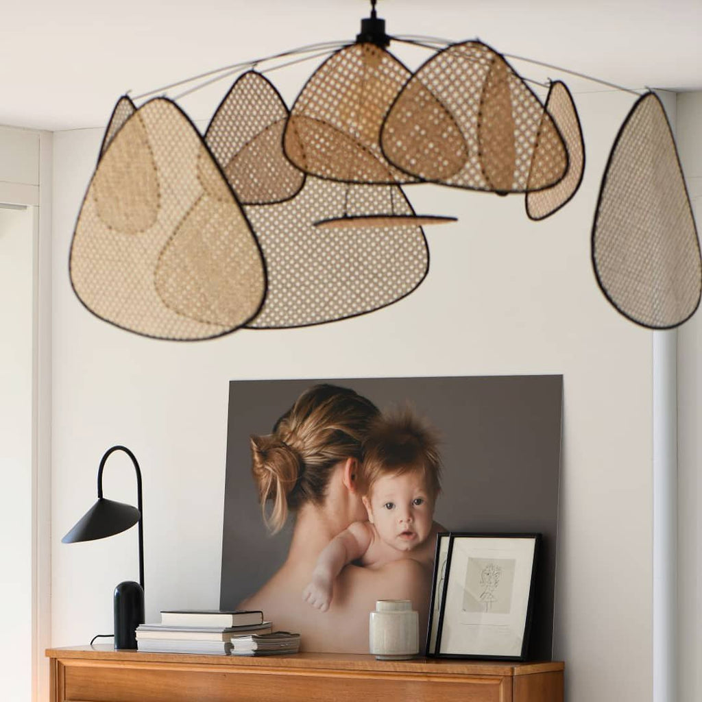 A console table dressed with books and a framed photograph sits beneath this Clérachic pendant.