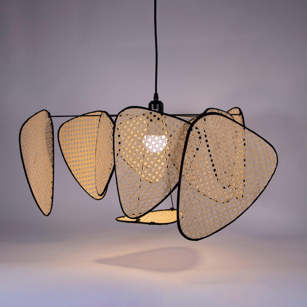 Against a lilac studio backdrop, light glows through the open bamboo weave of this Clérachic pendant's front-facing paddles.