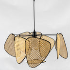 An angled studio view shows the underside of this Clérachic pendant's woven bamboo paddles and black metal frame.