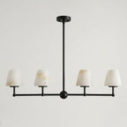 Shown alone on a plain backdrop, the straight bar and ball joints of this Clérachic chandelier appear in matte black.