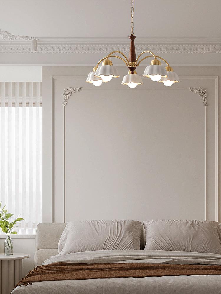 Swedish modern brass and walnut chandelier in a bright room